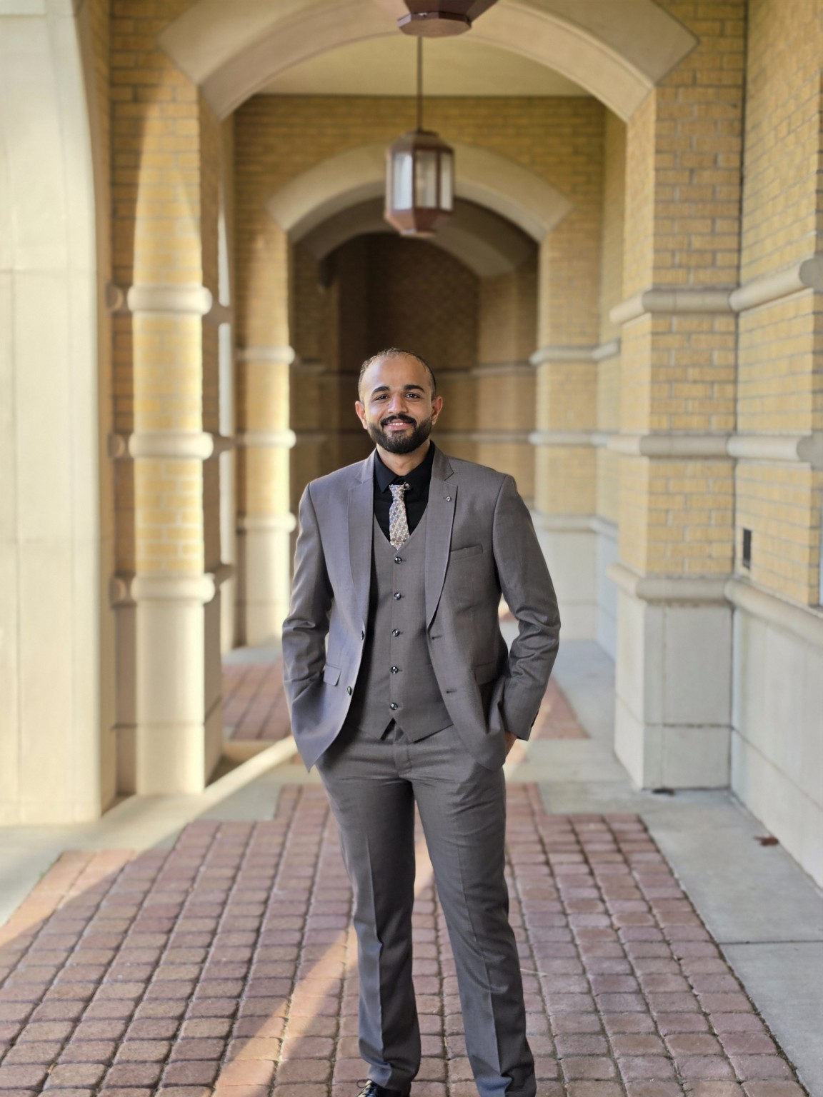 Hemant Sharma standing in a professional suit
